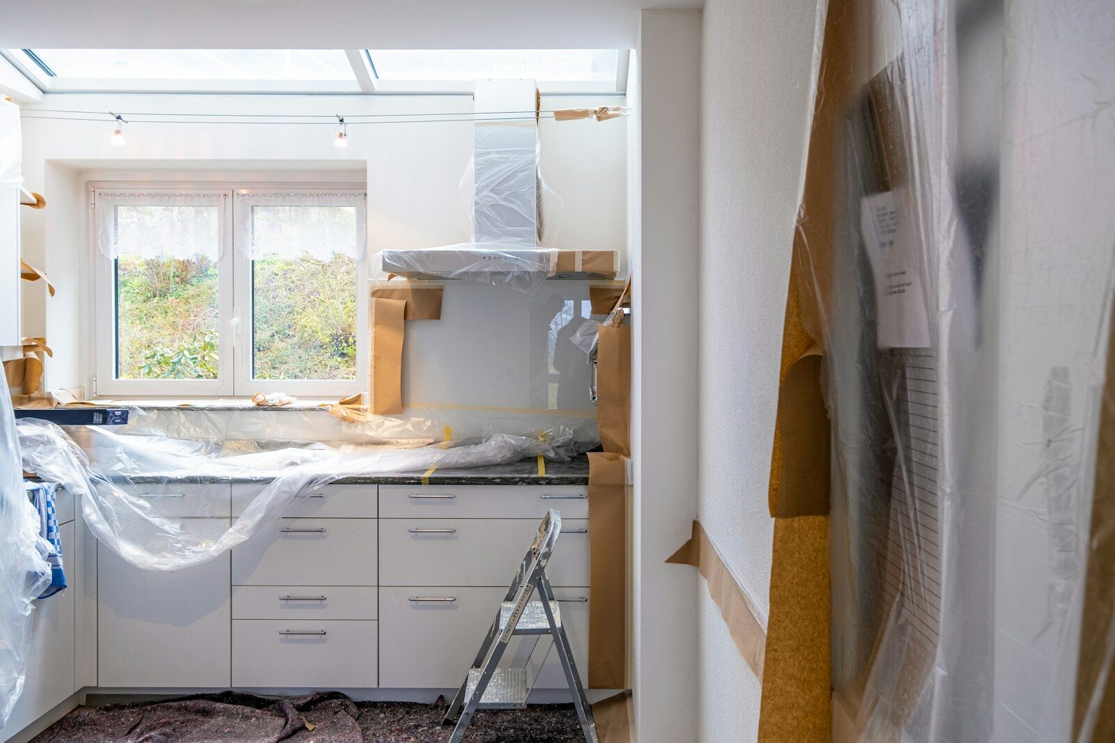 Photo by immo RENOVATION white wooden cabinet near window