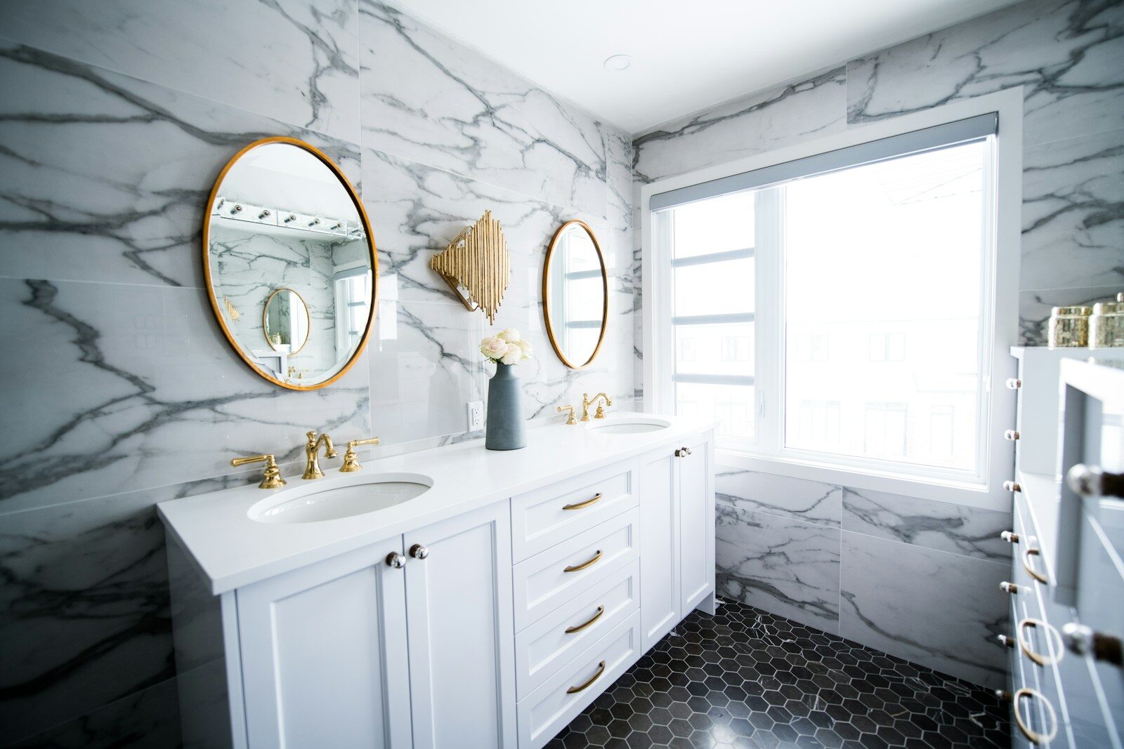 Photo by Christian Mackie a bathroom with two sinks and a large mirror
